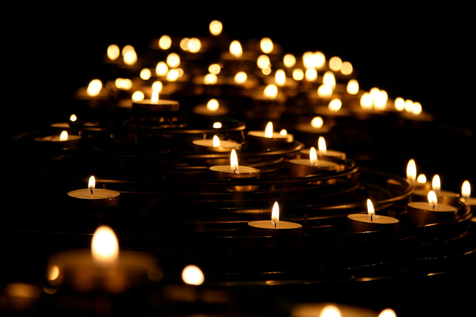small candles on fire in the dark lit room