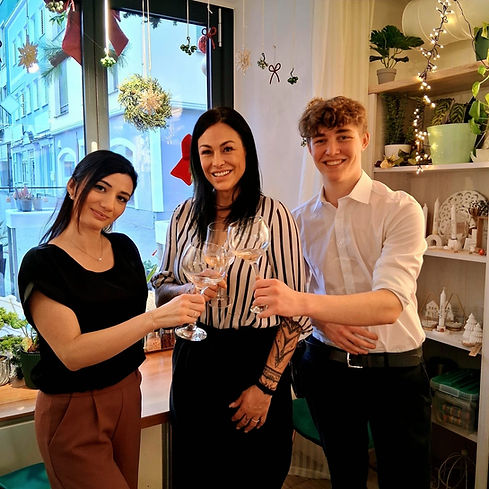 Freundliches Vivid Café Team im Innenraum, lächelnd und bereit für Gäste.