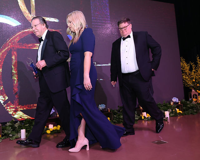 Frank DeLuca and two other people walking at event. Inspire Gala honors area philanthropists and nonprofits.