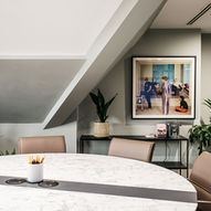 Modern meeting room with round table and artwork