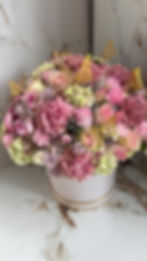 Roses, spray roses and butterflies on flowers in hat box