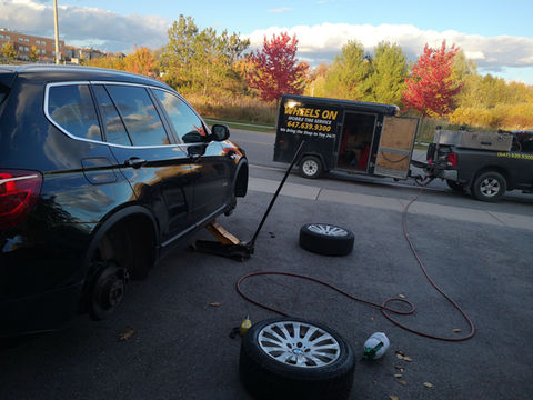 Tires being removed from black SUV