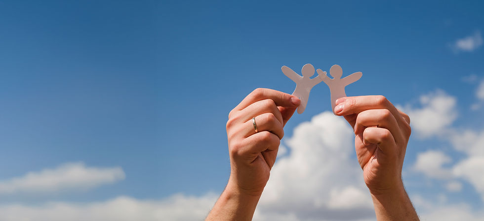 Hands holding together two paper people