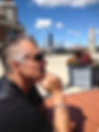 Matt Thorpe wearing sunglasses, sitting holding chin up with hand
