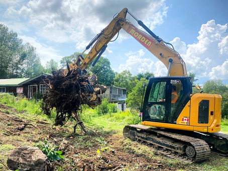 excavator digging up a yard