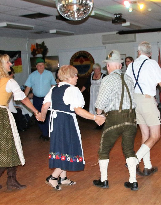 seniors dancing in a circle at the Oktoberfest event