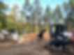 excavator working in a clearing in the forest by Morden Construction Inc.