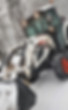 White front loader clearing snow from property — commercial snow removal services