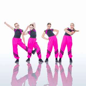 four dancers in bright pink pants and black top with bright pink design