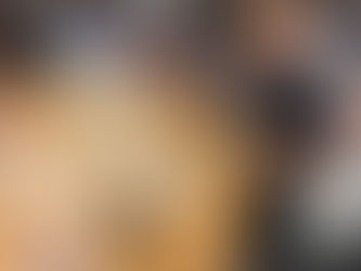 Young students partaking in arts and crafts with smiling faces.