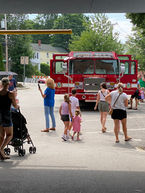 Members of the public interacting with a firetruck.