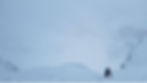 A climber ascends a snowy slope in a wintry landscape, surrounded by snow-covered trees and a foggy sky, creating a serene, challenging scene.