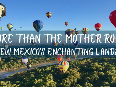 Hot air balloons of various colors float over a river and green landscape under a clear blue sky. Text says, "More Than the Mother Road: New Mexico’s Enchanting Lands."