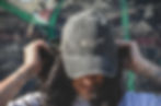 woman adjusting clothing wearing grey dad hat