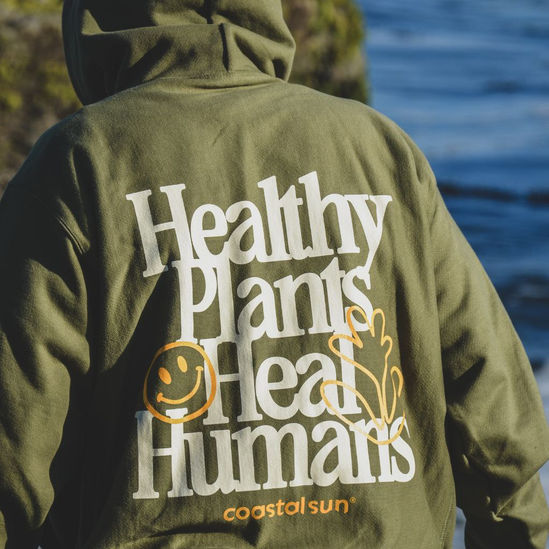 Model wearing Healthy Plants Heal Humans® hoodie. Click to go to product page.