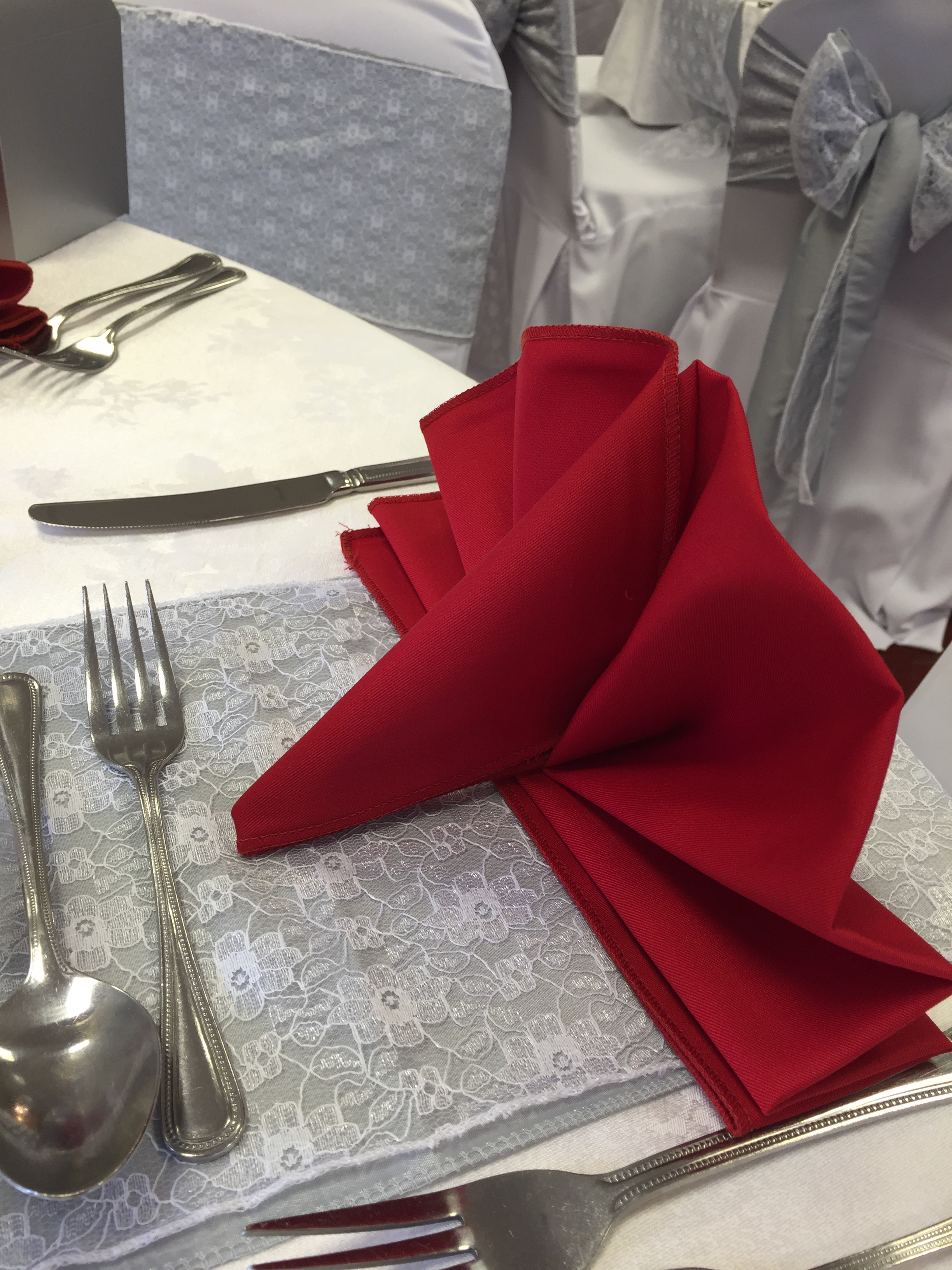 Fan style folded red linen napkin