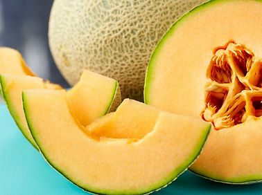 a-close-up-of-a-sliced-cantaloupe-on-a-blue-table.jpg