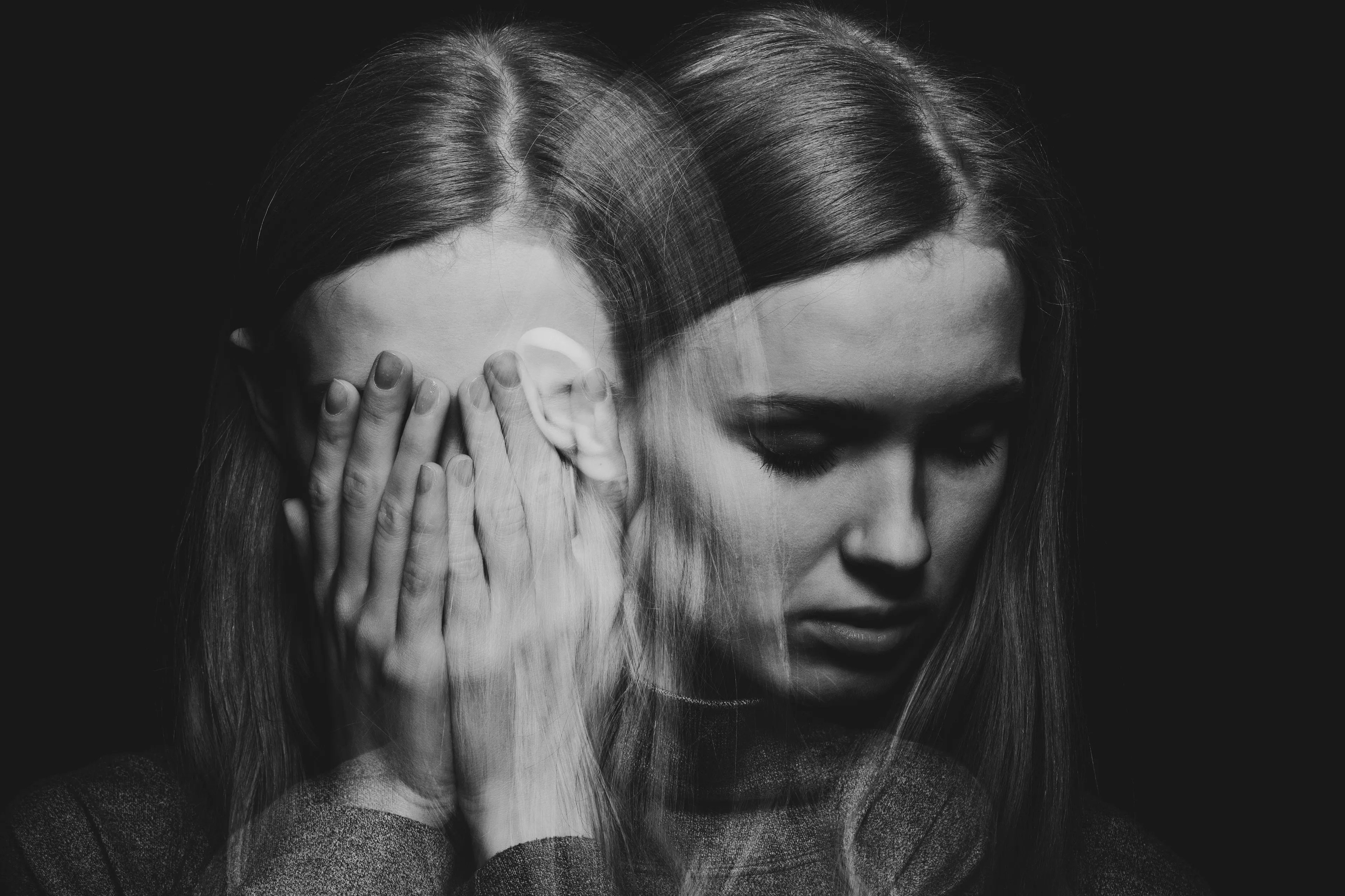 a women with her hands covering her face