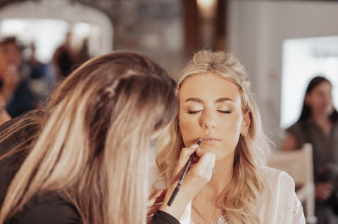 Bridal MUA applying lipstick