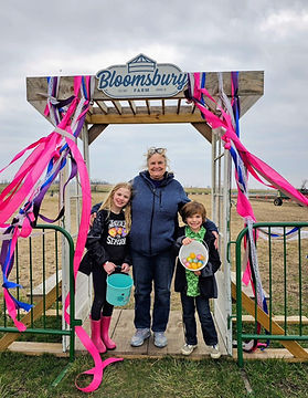 family of three holding easter baskets under a photo op