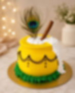Yellow pot cake with peacock feather, a tasty treat.