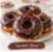 Chocolate glazed donuts with sprinkles, a tasty treat.
