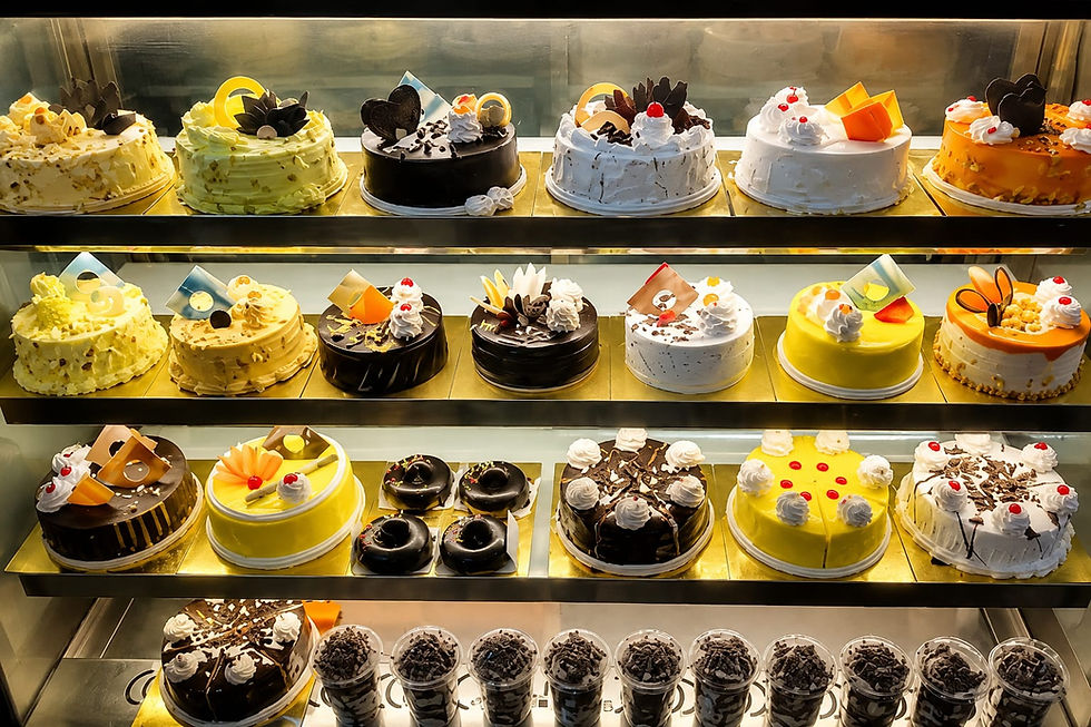 Display case filled with cakes, a perfect tasty treat.