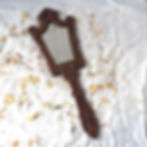 antique carved hand mirror with bevelled mirror