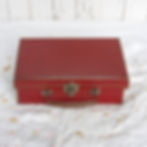 small vintage red cardboard suitcase with metal handle