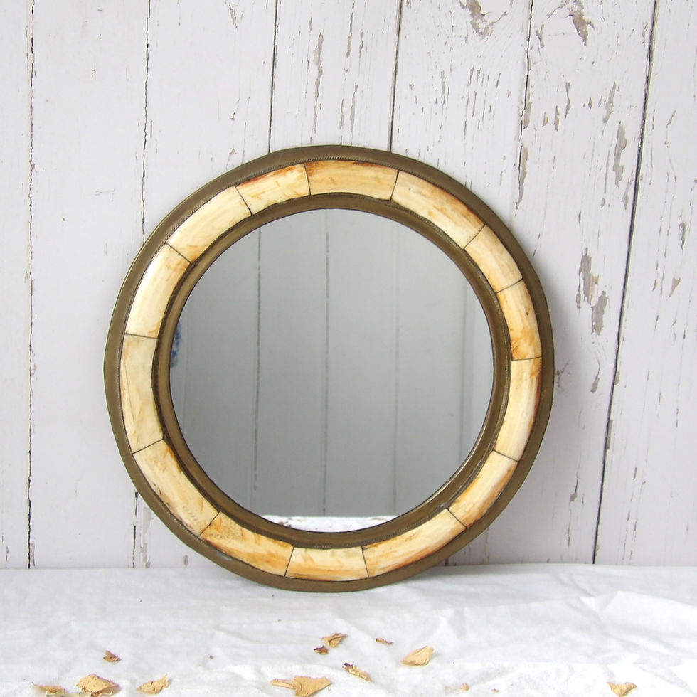 round vintage brass mirror with faux bone decoration