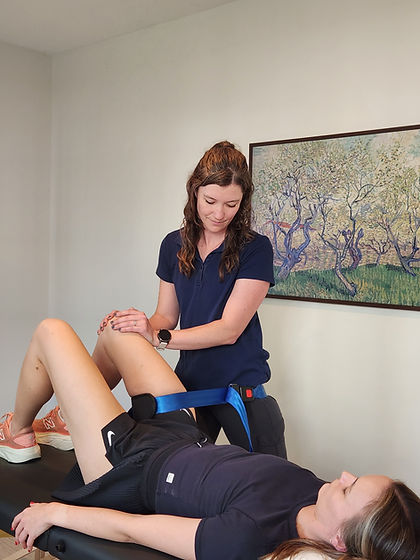 Physical therapy providing hip traction to a patient