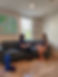Physical therapist talking to a patient on a couch