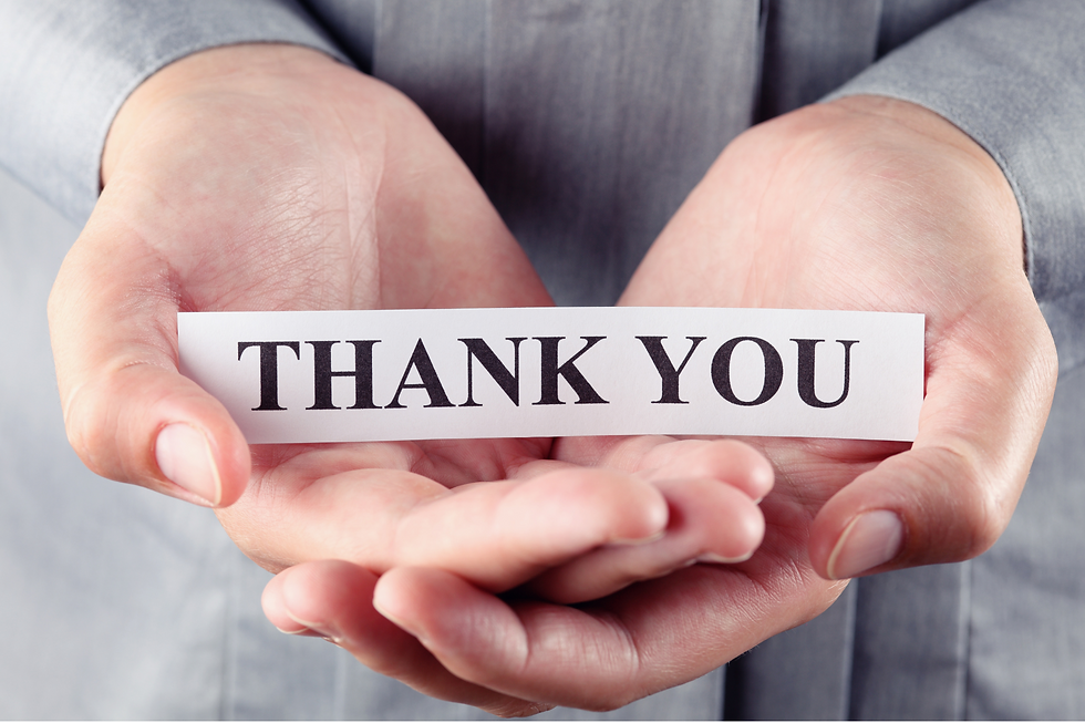 Hands holding a slip of paper that says thank you