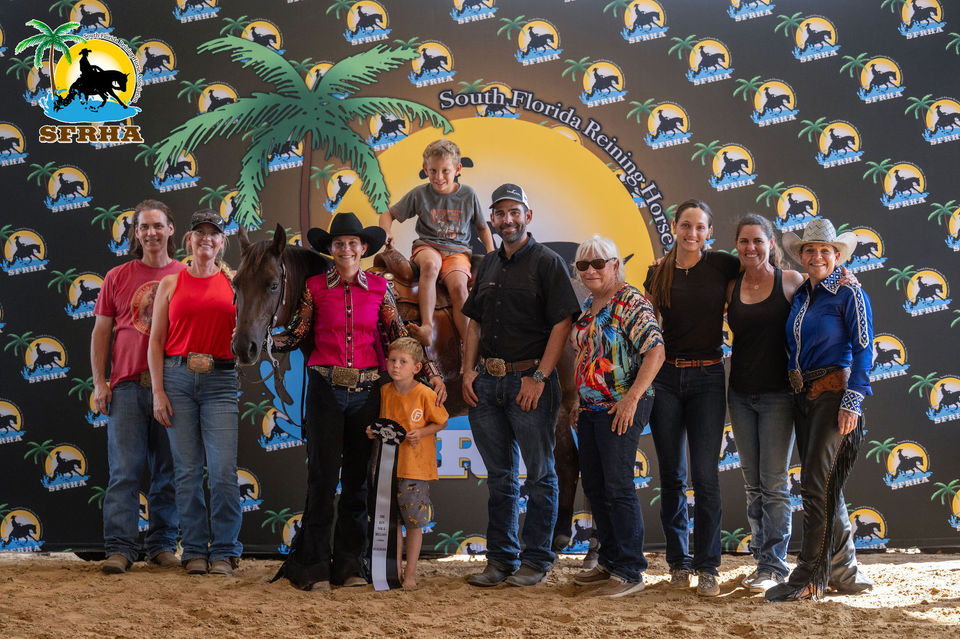 Group photo posing next to a horse at SFRHA event.