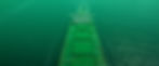 Panoramic view of a cargo ship in the middle of the ocean.