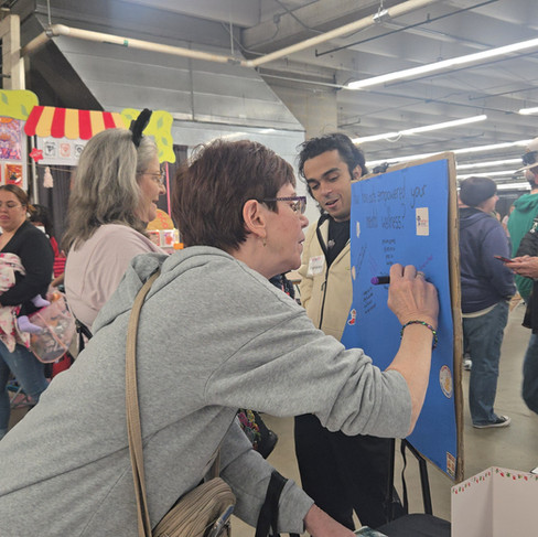 Event attendees writing on how cats have empowered their mental wellbeing