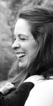 A profile image of Catherine Middlebrooks, a postnatal yoga teacher, smiling at her child