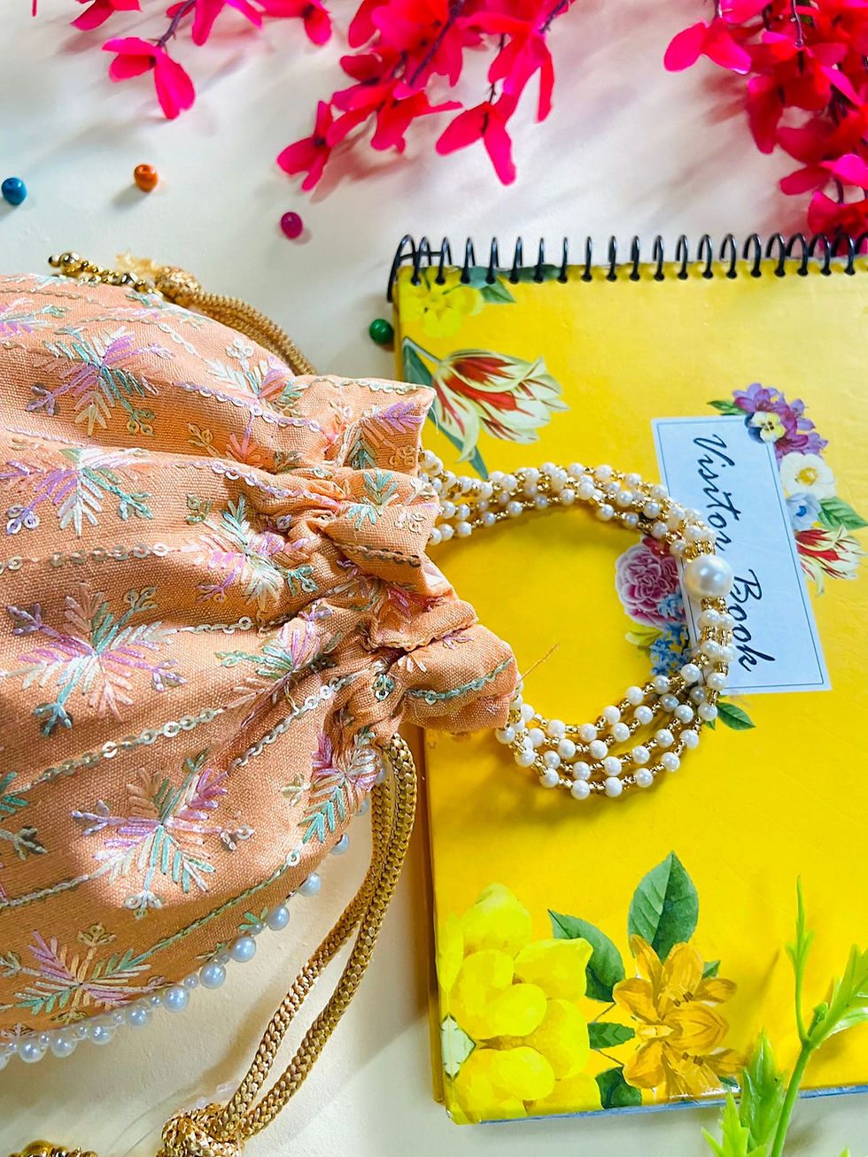 Thumbnail: Women Peach Floral Embroidered potli bag with Pearl handle and latkan