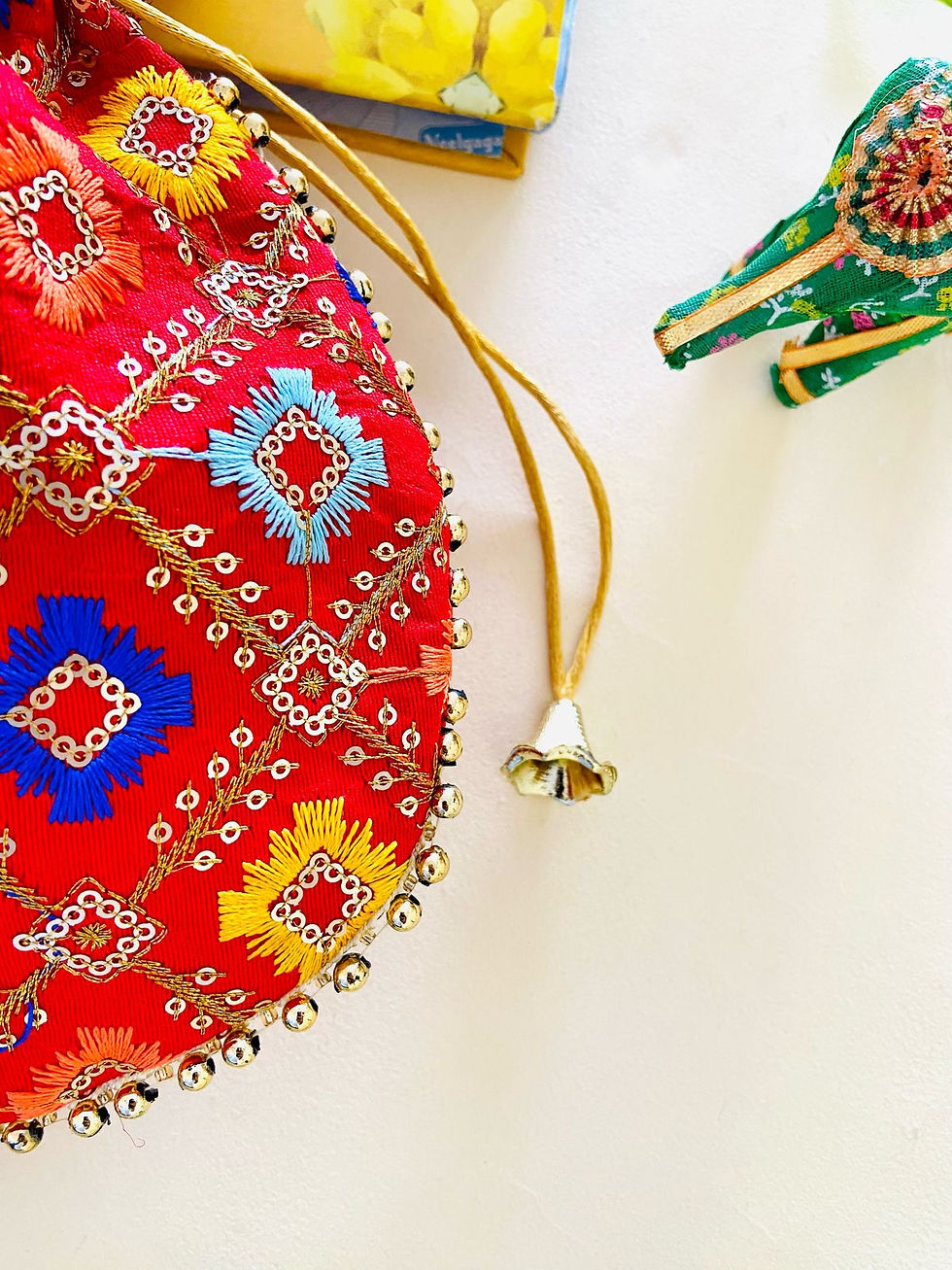 Thumbnail: Women Red Embroidered Designer Potli bag with Pearl Handle and latkan