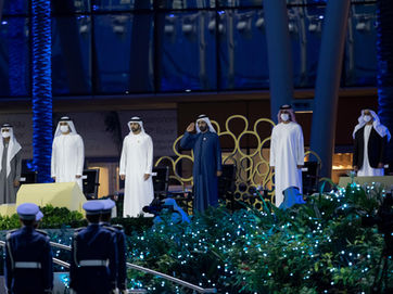 Event Photographer UAE capturing a formal outdoor ceremony with leaders on stage, blue lighting, and an official audience in attendance.