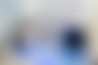 Corporate Photography UAE capturing executives touring a modern exhibition space, viewing an interactive digital map display.