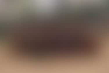 Street Photography Documentary capturing a group of smiling children gathered by a riverside in an urban neighborhood.