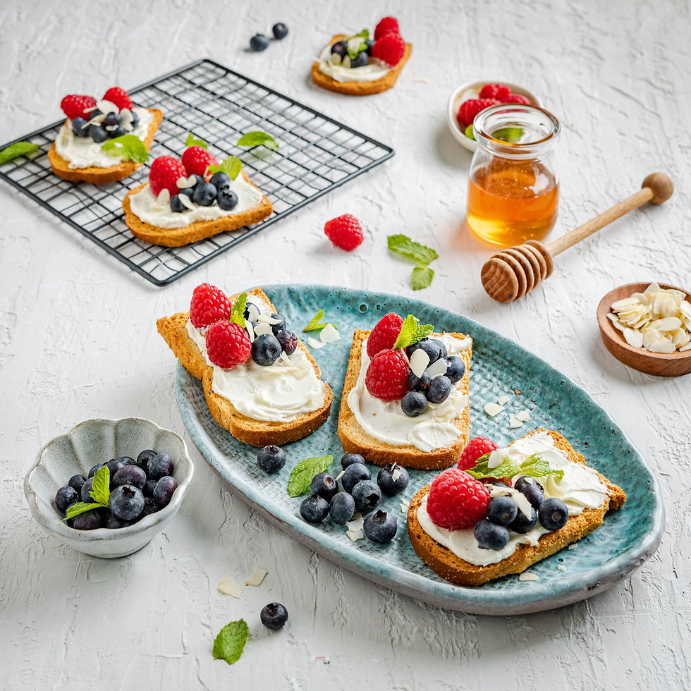 Food photographer ideas: bright flat-lay of berry toast with cream cheese, honey and almonds on textured white background for healthy breakfast branding