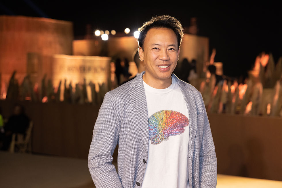 complementary colors portrait photography of a man at a night event, warm lights behind and cool-toned jacket creating striking color contrast.
