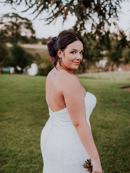 bride in a white wedding dress with a lake in background