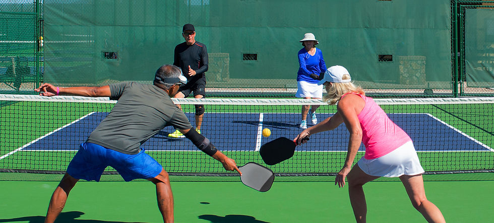 Group of four older adults playing pickleball, promoting active living and healthy movement.