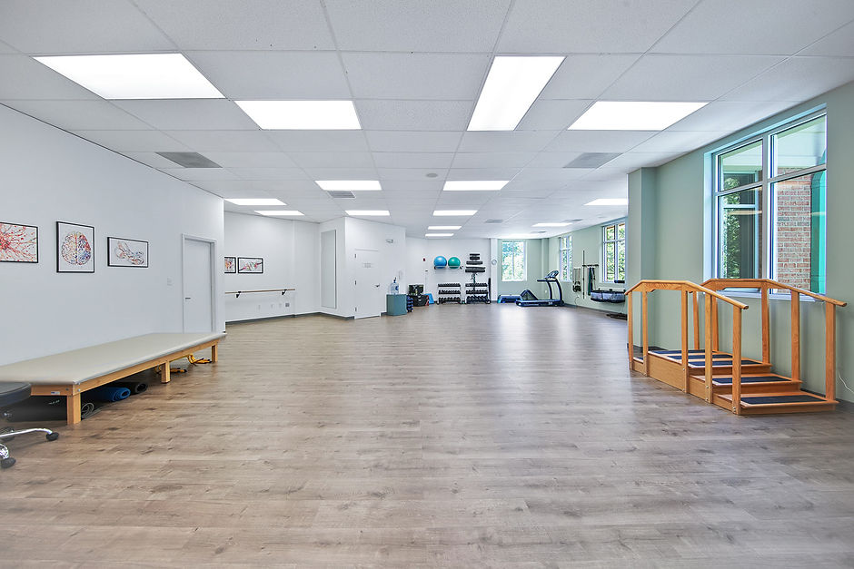 Inside view of Proactive Motion Physical Therapy clinic with equipment and exercise space.