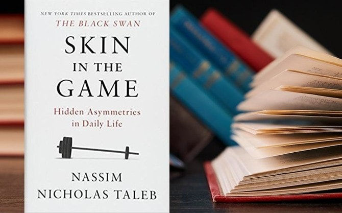 Skin in the Game book, with other books in background