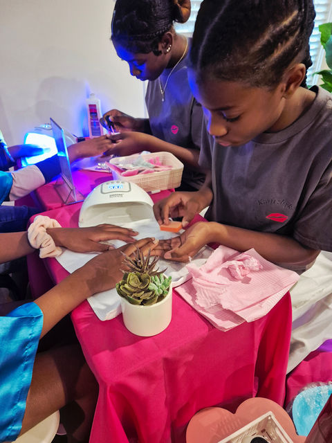 Girls doing manicure, products and tools on pink table. KraftzbyKadin