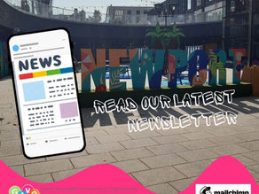 The image shows the mock up of a mobile phone displaying GAVO news, it is placed in front of a colourful Newport sign placed in the Chopping centre area of the city
